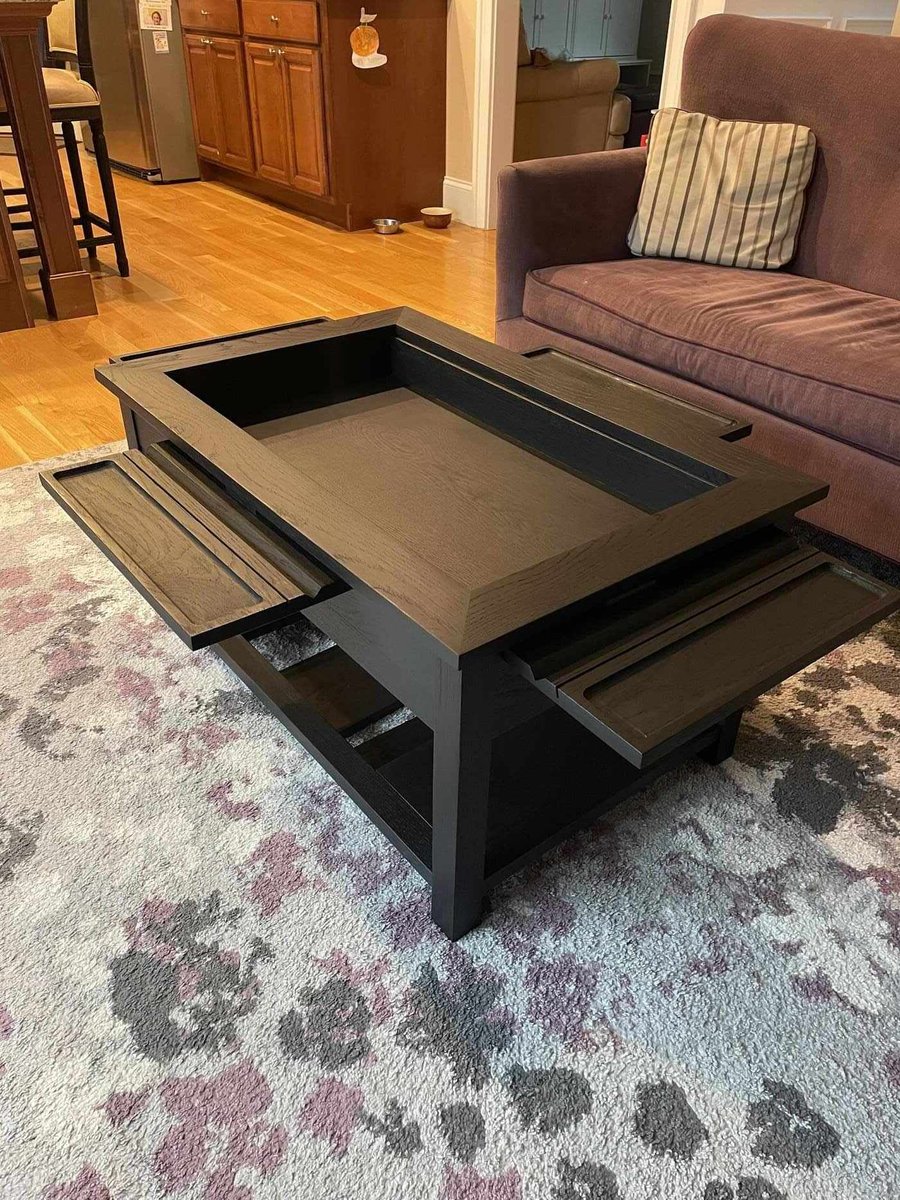 Custom black wood coffee table with sliding trays and storage in a Central Connecticut home by Riverbend Renovations