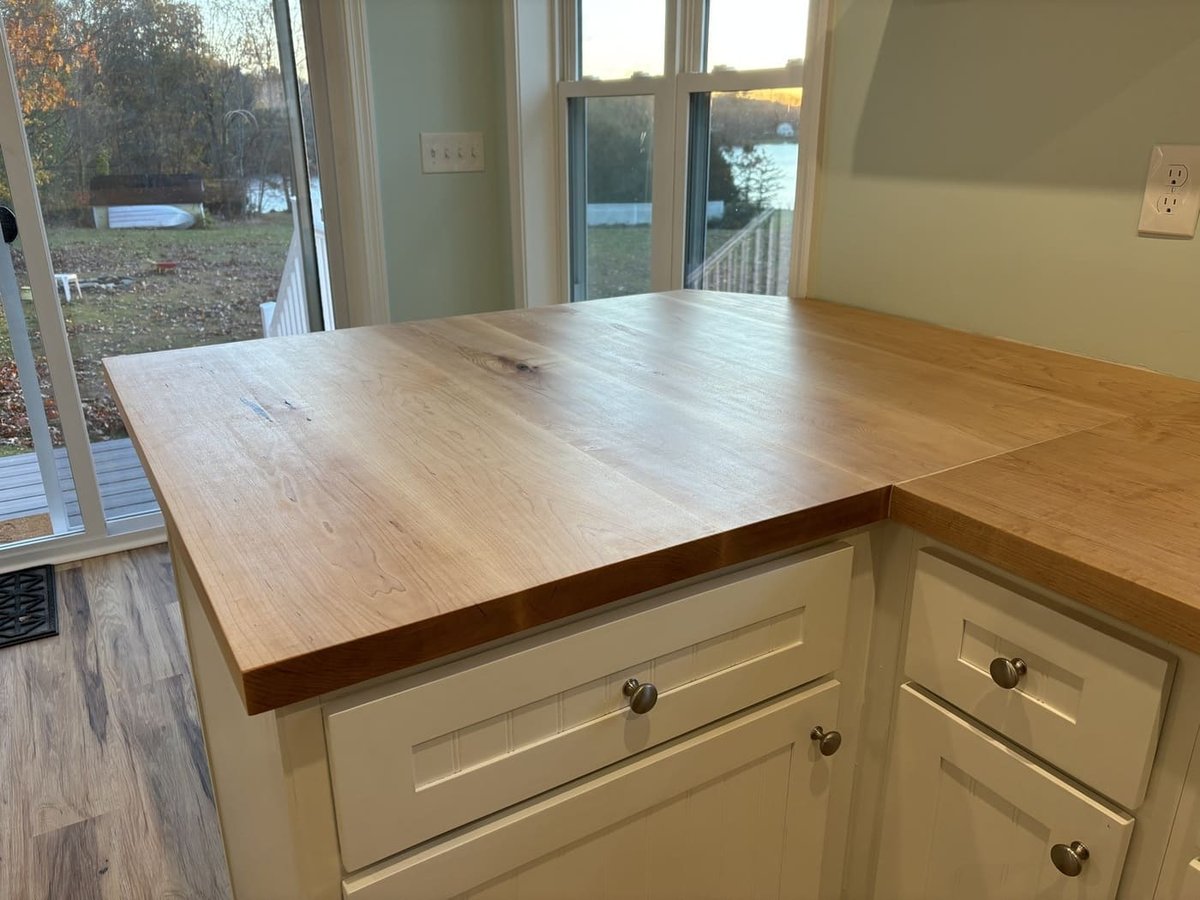 Custom wood countertop on white cabinetry with lake view in a Central Connecticut home by Riverbend Renovations