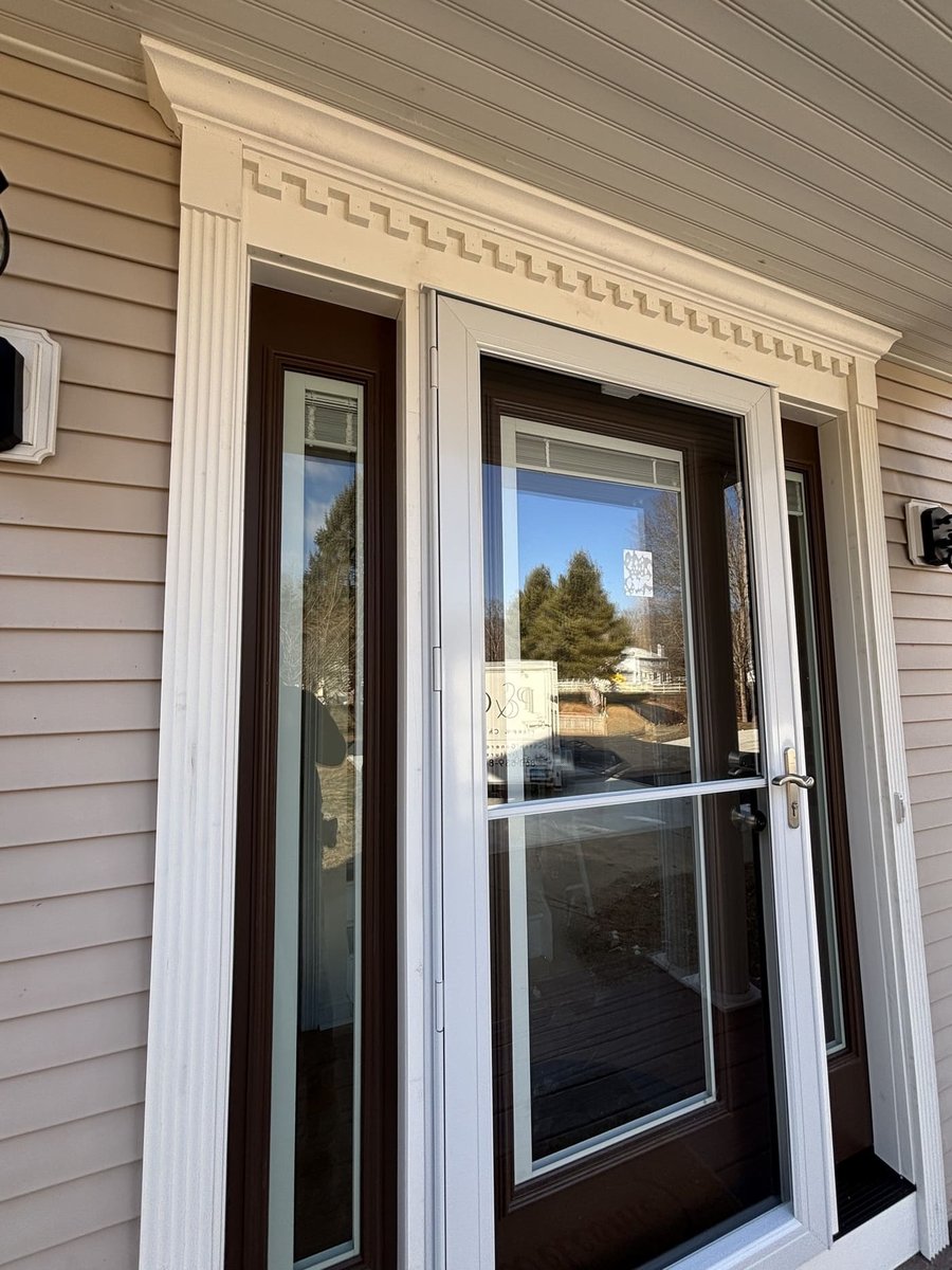 Front entry door with decorative trim and sidelights at a Central Connecticut home by Riverbend Renovations