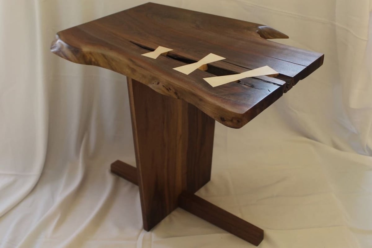 Live edge walnut side table with butterfly inlays on pedestal base in Central Connecticut by Riverbend Renovations