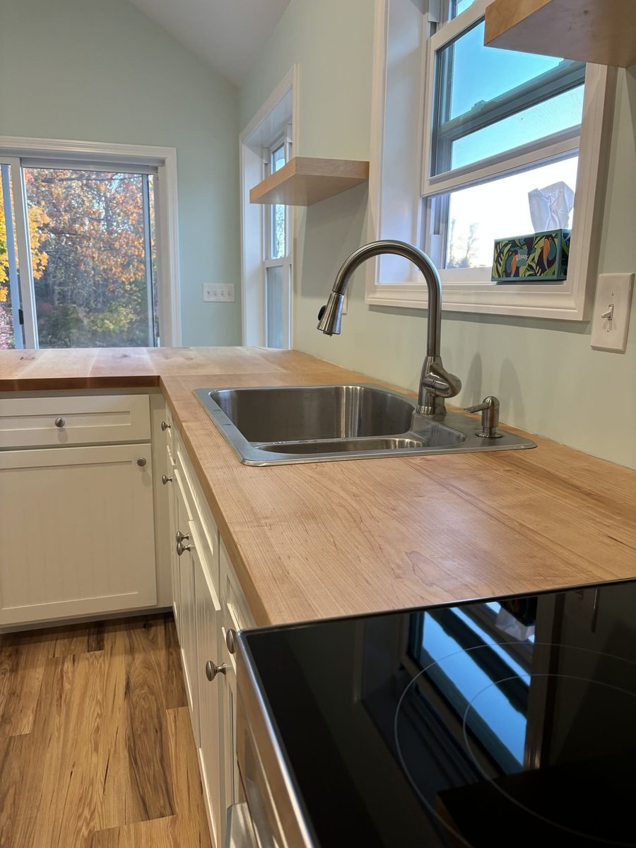 Wood countertop with sink and window views in a Central Connecticut home by Riverbend Renovations