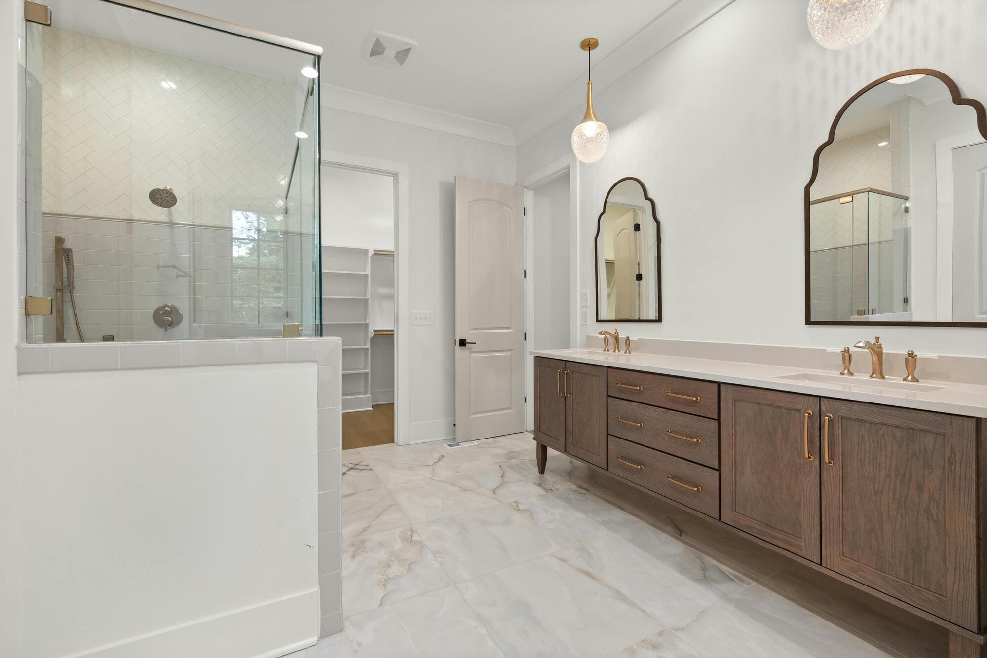 Stock image of bathroom with double vanity, glass shower, and modern fixtures in East Hampton, CT