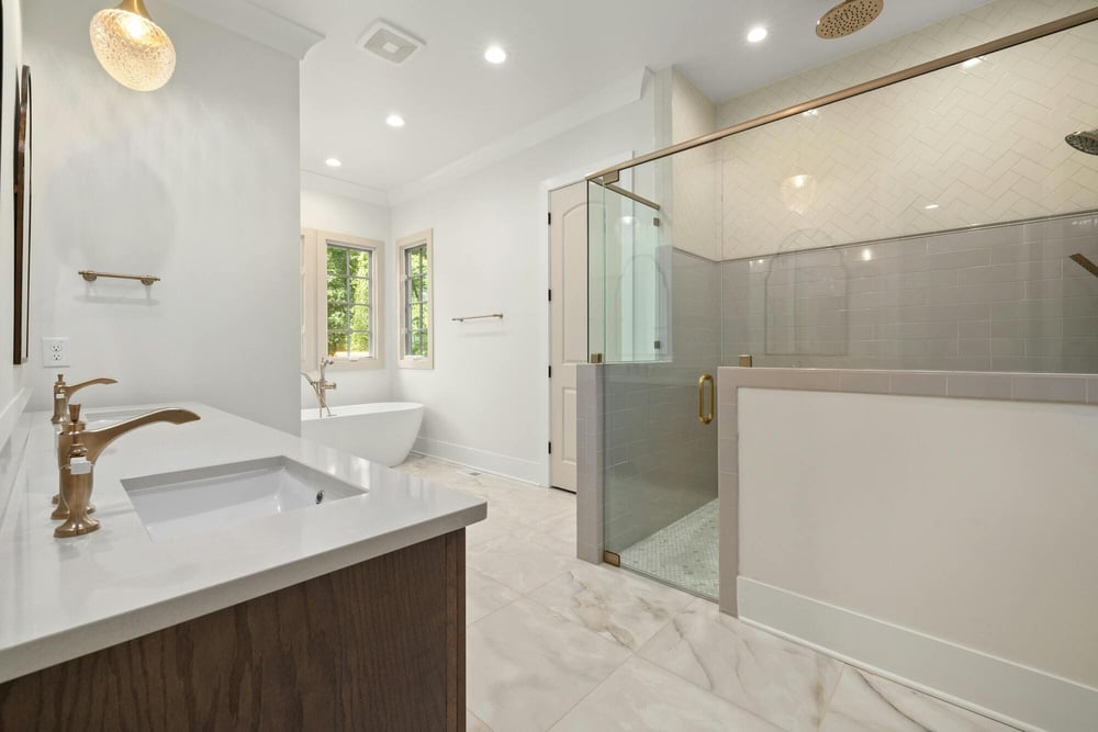 Bright remodeled bathroom with walk-in shower, freestanding tub, and double vanity in East Hampton, CT