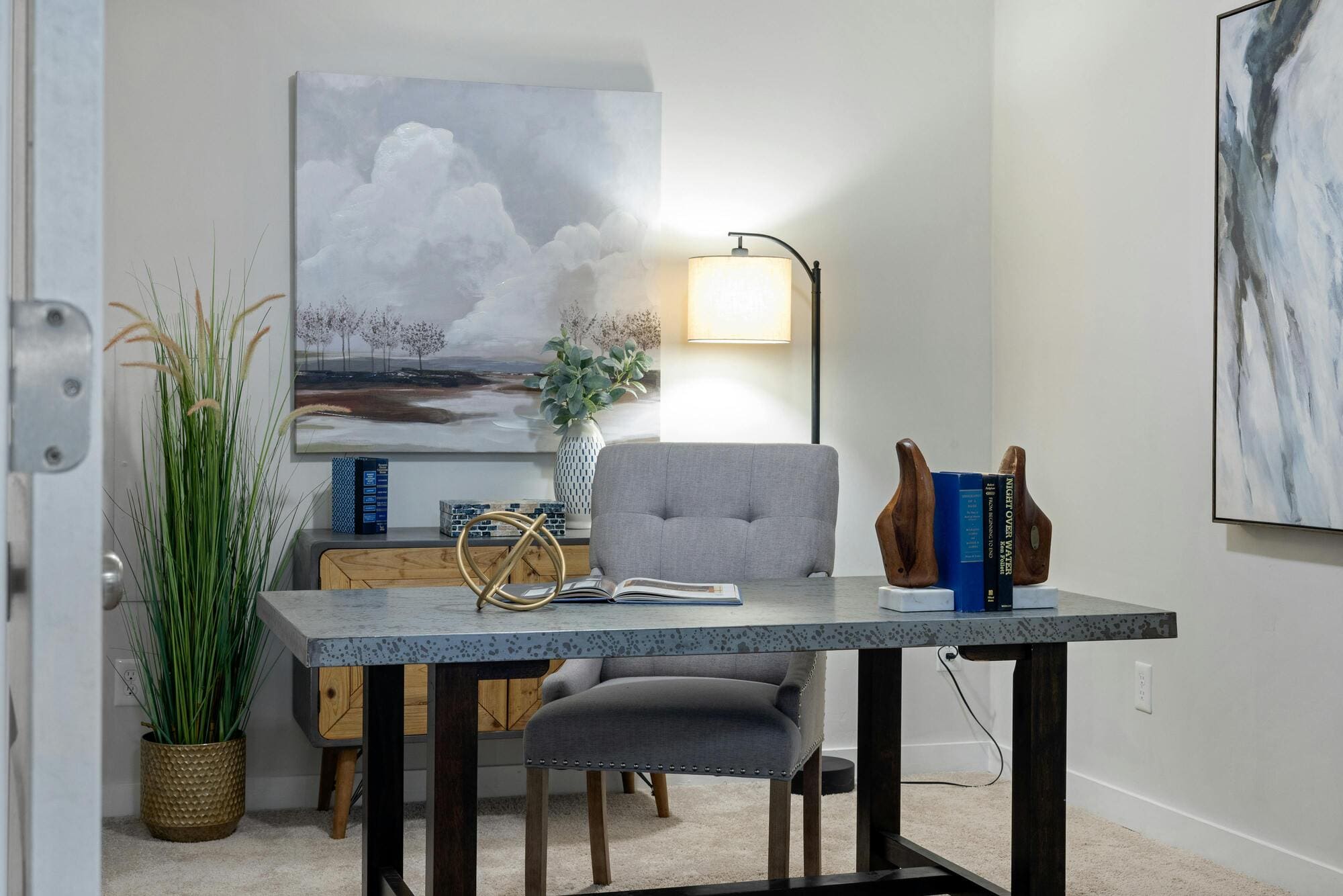 Stock image of home office with desk, chair, lamp, and wall art decor in South Windsor, CT