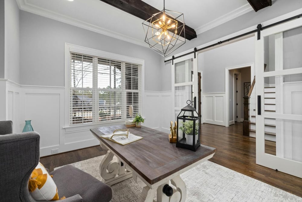 Riverbend Renovations home office with wood desk, sliding barn doors, beams, and modern lighting in Colchester, CT