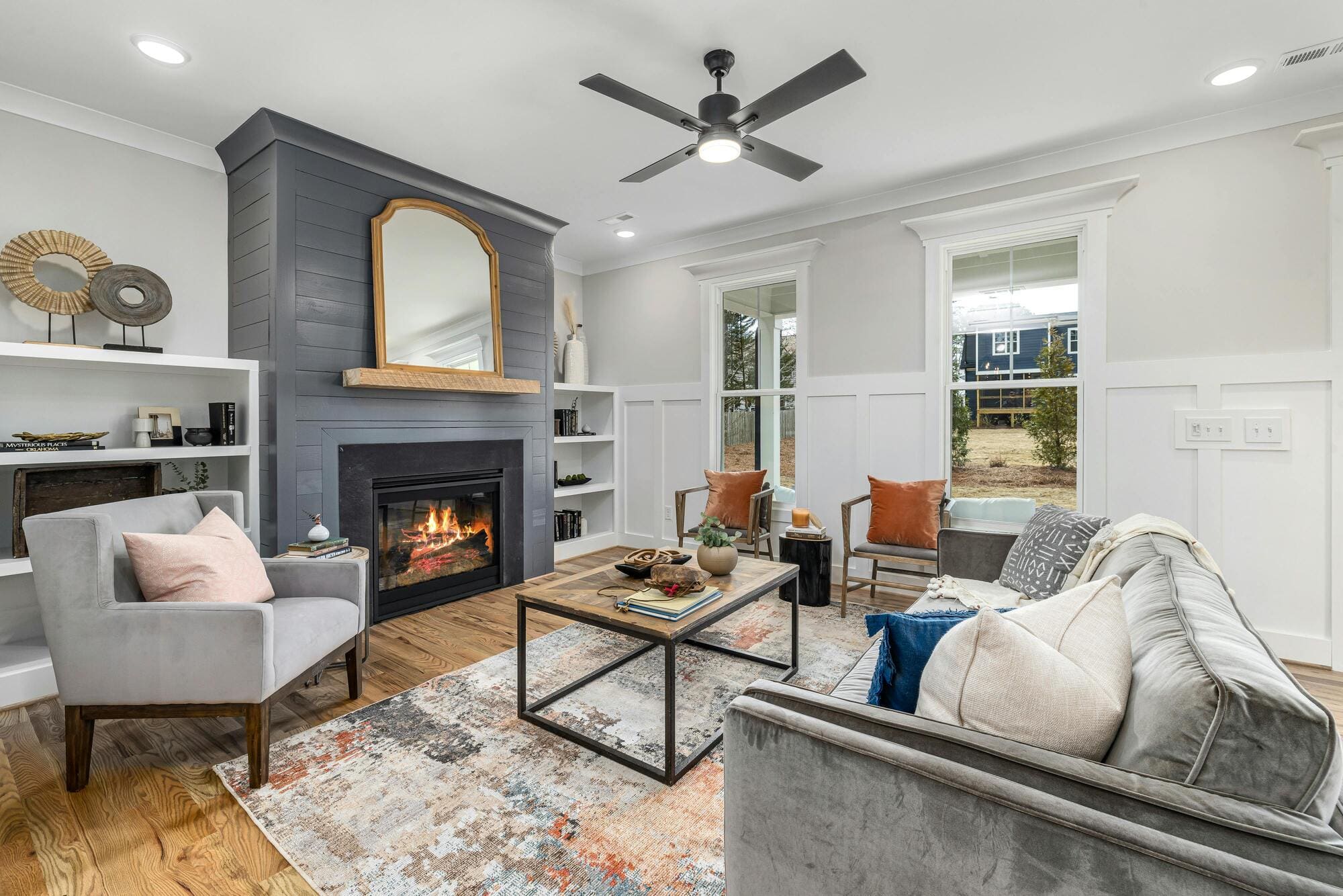 Stock image of living room with fireplace, gray accent wall, and modern seating in Central Connecticut