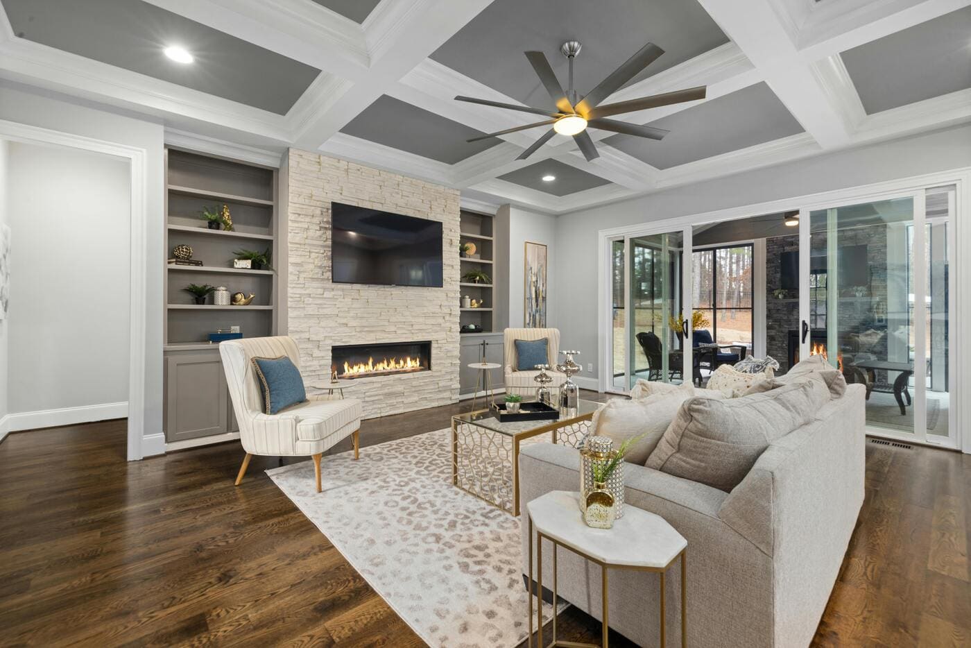 Modern living room remodel with fireplace, coffered ceiling, and large windows in Glastonbury, CT